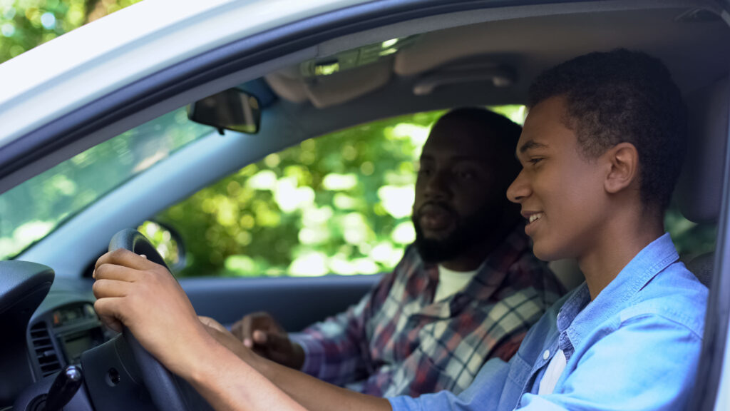 Young driver getting experience to improve car insurance rates