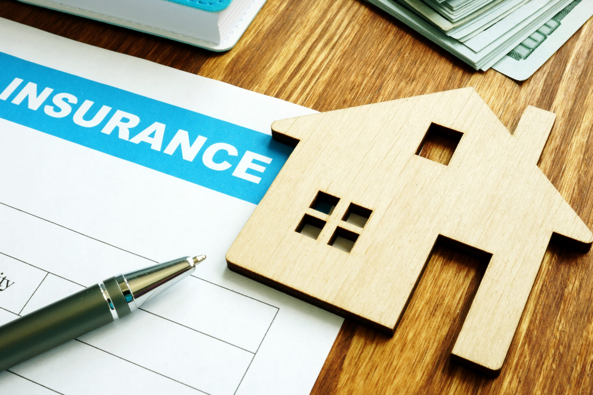 Home insurance form for homeowners and model of home.