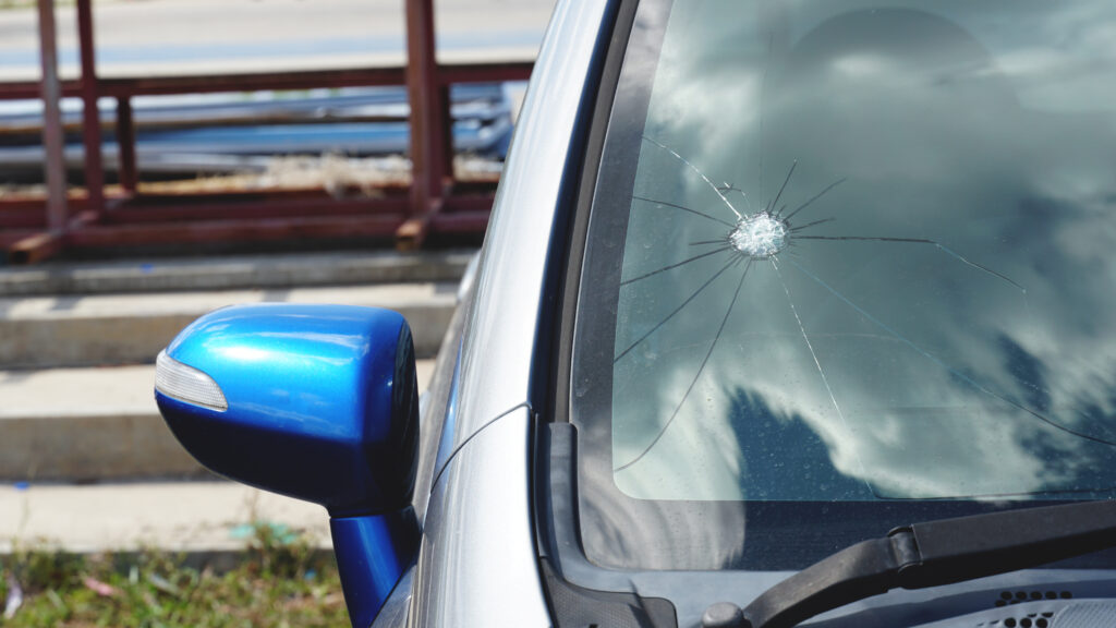 Broken windshield on blue car
