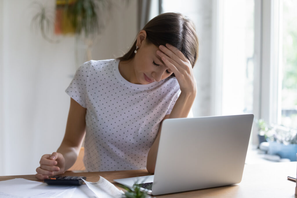 Stressed woman looking at laptop computer
