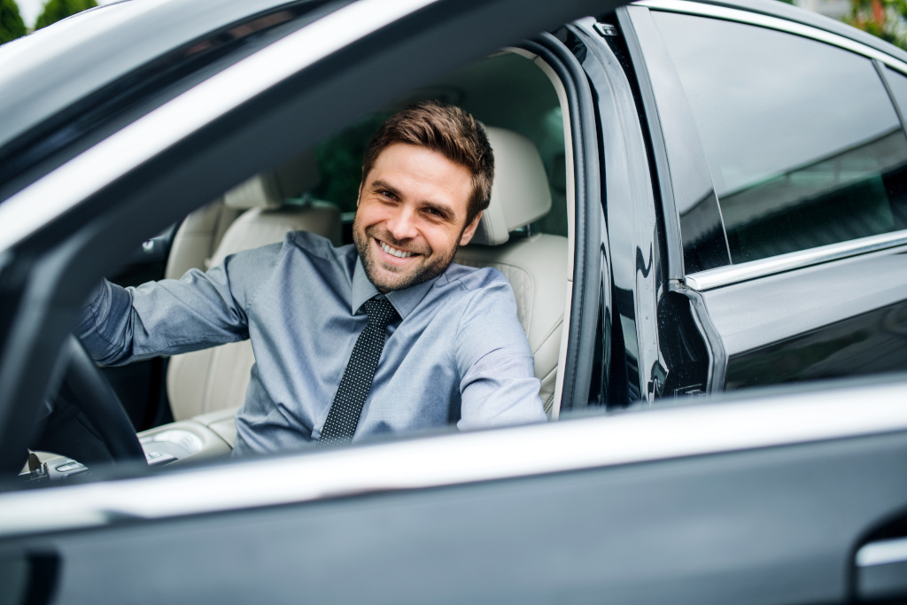 Man in car with smile on his face.